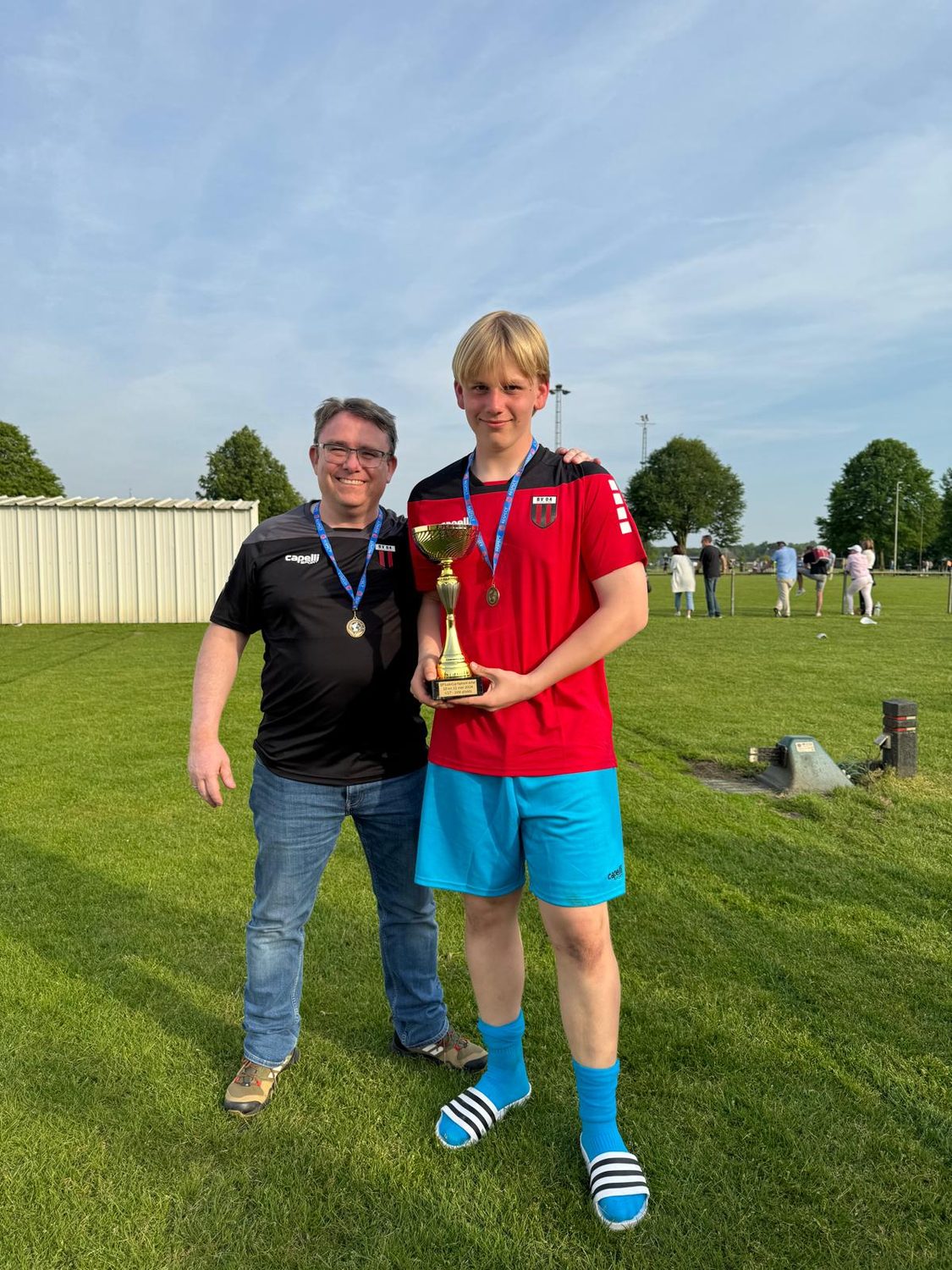 Bene und sein Vater mit Pokal und Medaillen nach dem Turniersieg
